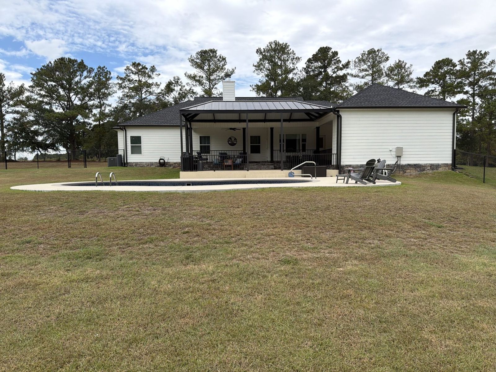 Rear of house with pool and patio cover