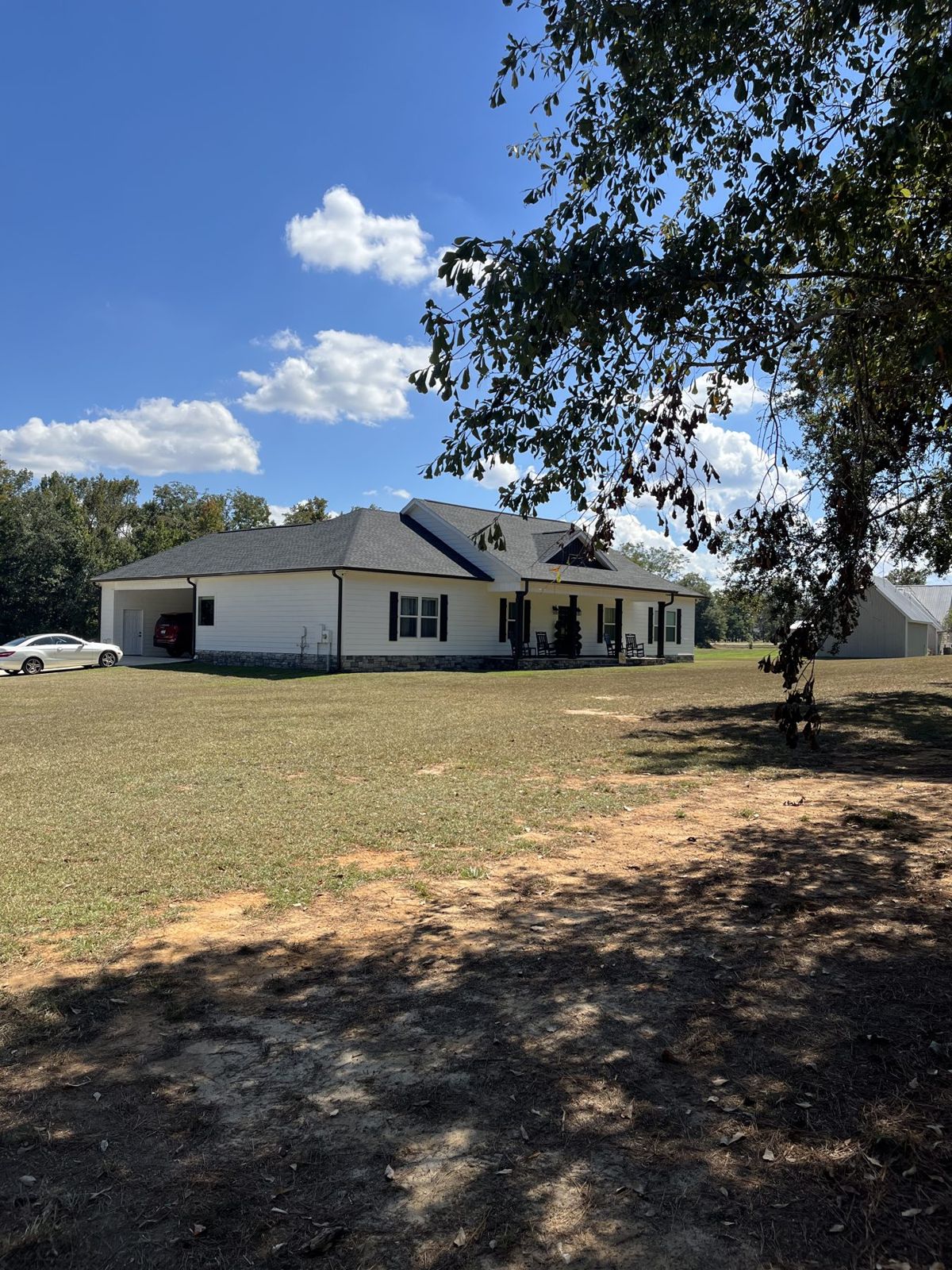 House and attached carport from the side yard