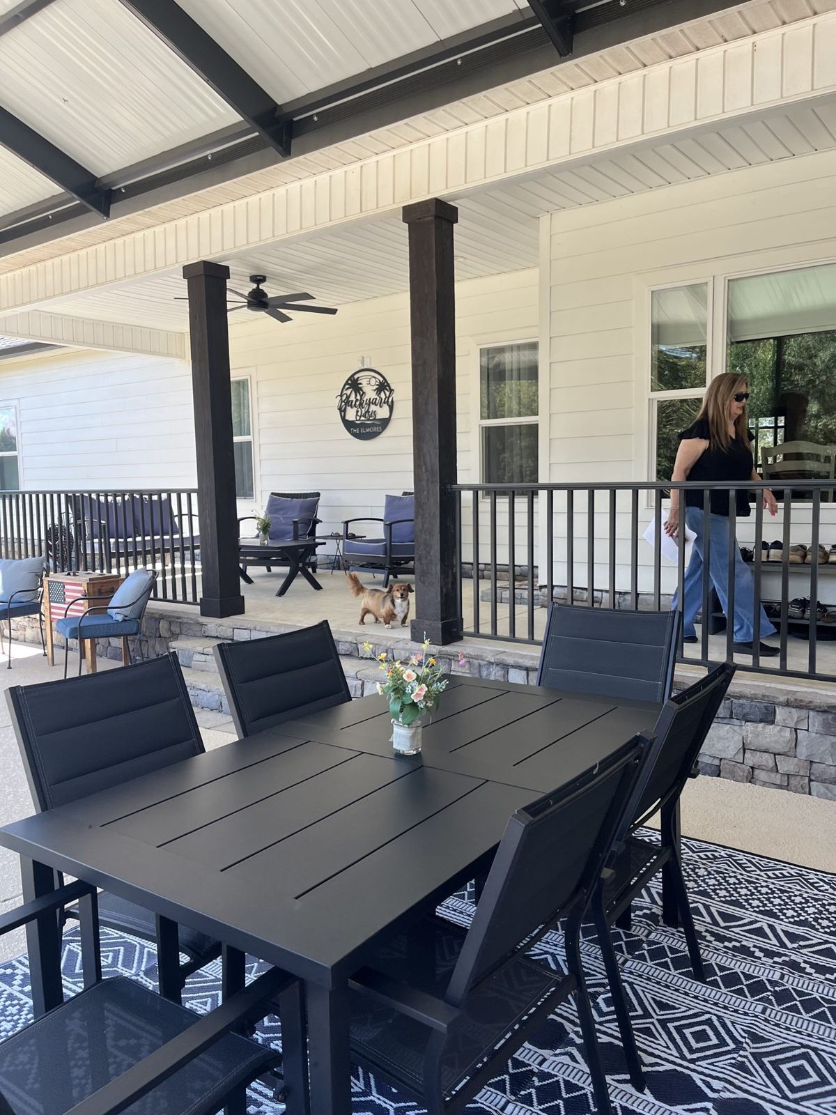 Covered rear porch with stone base and lap siding